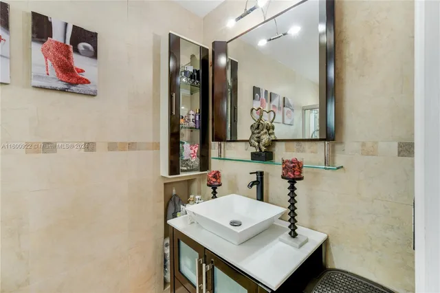 a bathroom with a sink vanity and a mirror