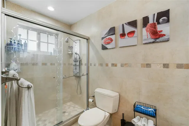 a bathroom with a toilet and a shower