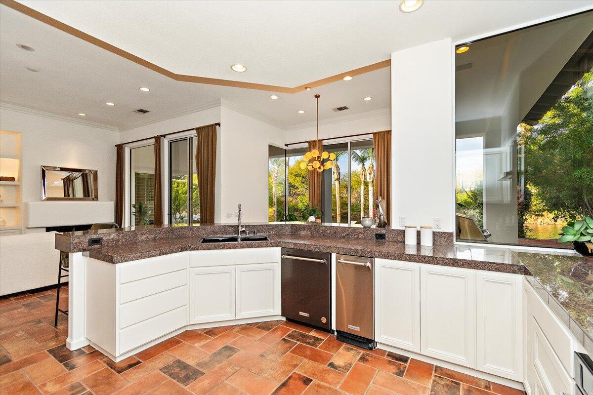 215 Loch Lomond Road Rancho Mirage, CA 92270 - Photo 13 of 57 a kitchen with a sink stove and cabinets