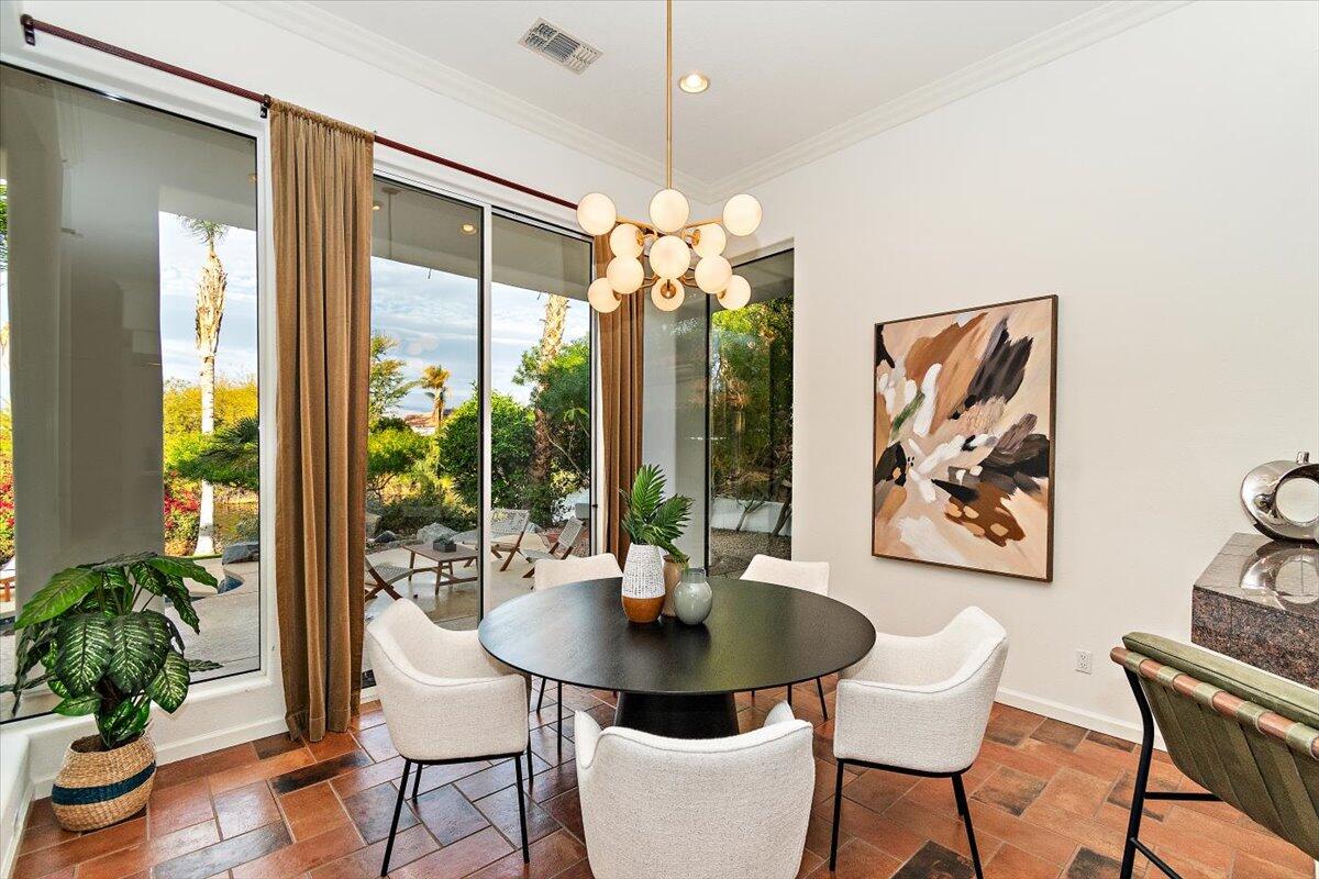 215 Loch Lomond Road Rancho Mirage, CA 92270 - Photo 14 of 57 a view of a dining room with furniture window and wooden floor