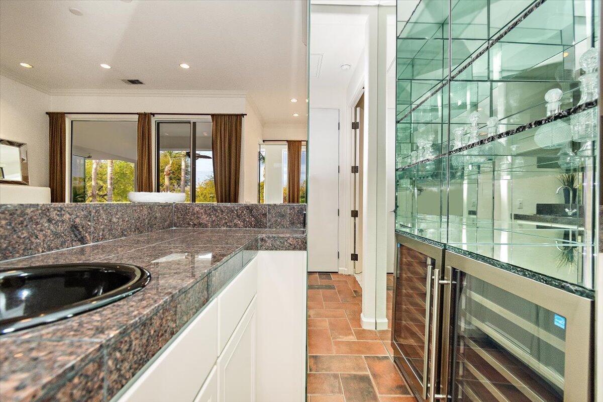 215 Loch Lomond Road Rancho Mirage, CA 92270 - Photo 16 of 57 a large kitchen with a large window and stainless steel appliances
