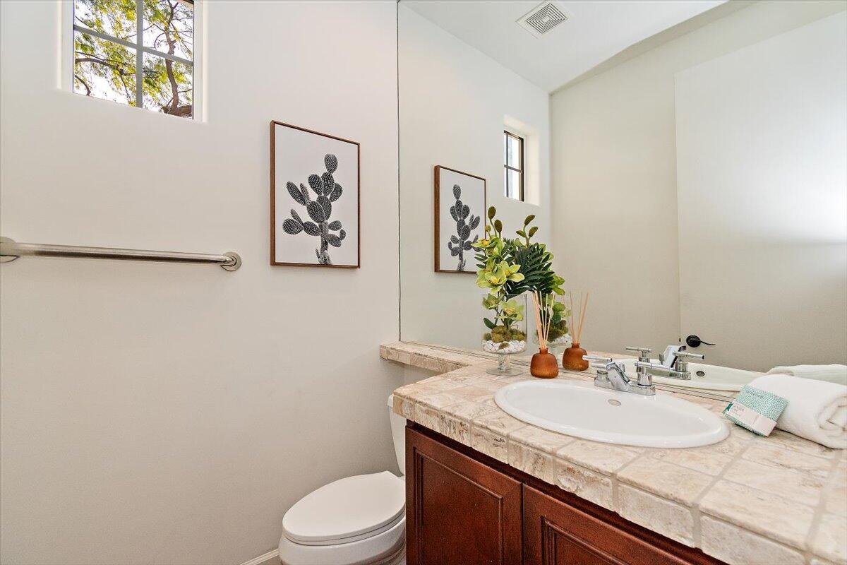 215 Loch Lomond Road Rancho Mirage, CA 92270 - Photo 19 of 57 a bathroom with a granite countertop sink a toilet and mirror