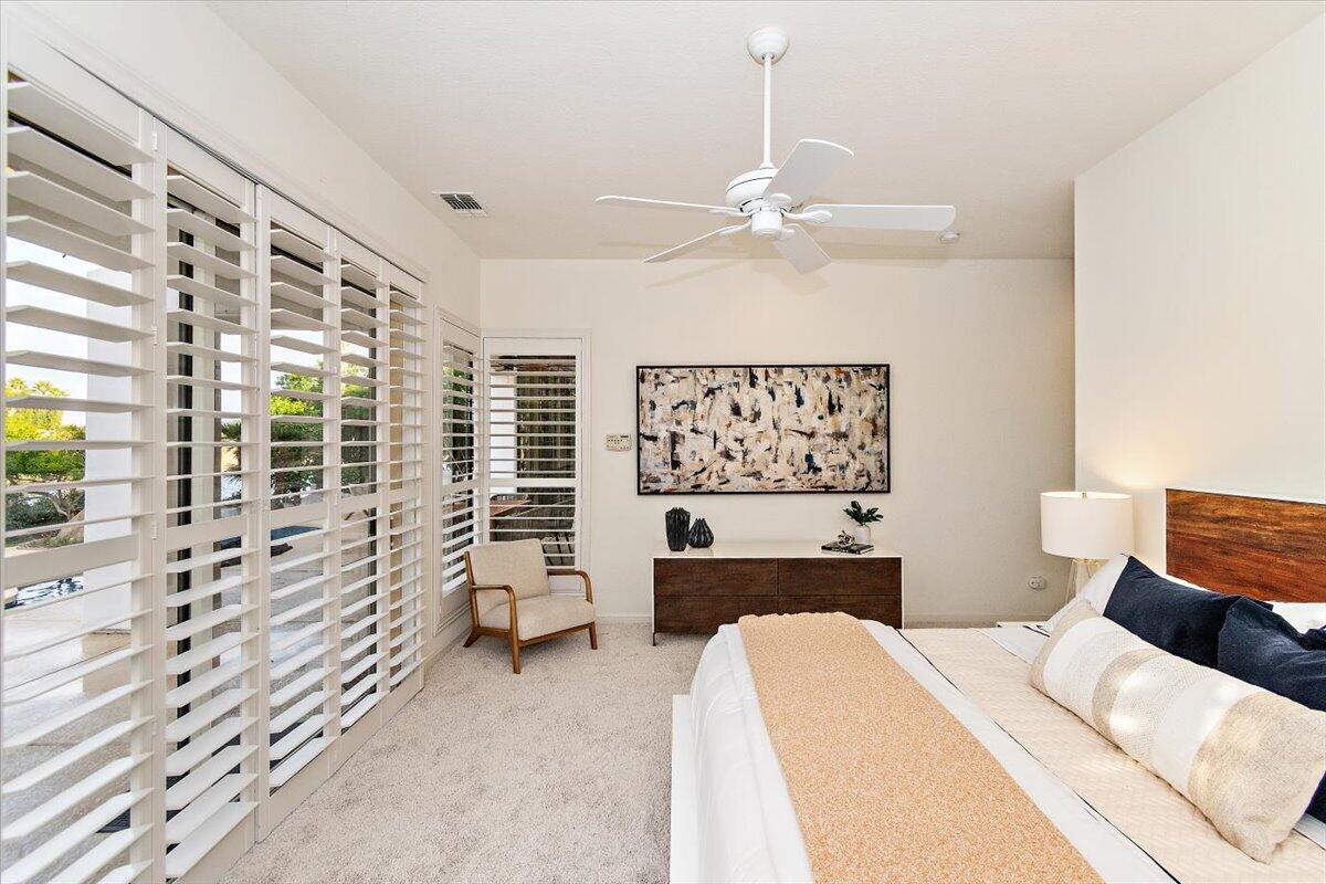 215 Loch Lomond Road Rancho Mirage, CA 92270 - Photo 22 of 57 a bedroom with a bed couch and window