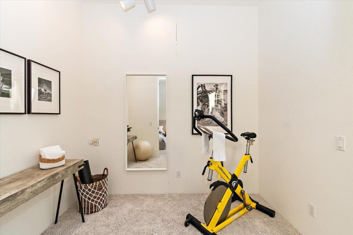 215 Loch Lomond Road Rancho Mirage, CA 92270 - Photo 31 of 57 a room with gym equipment and wooden floor