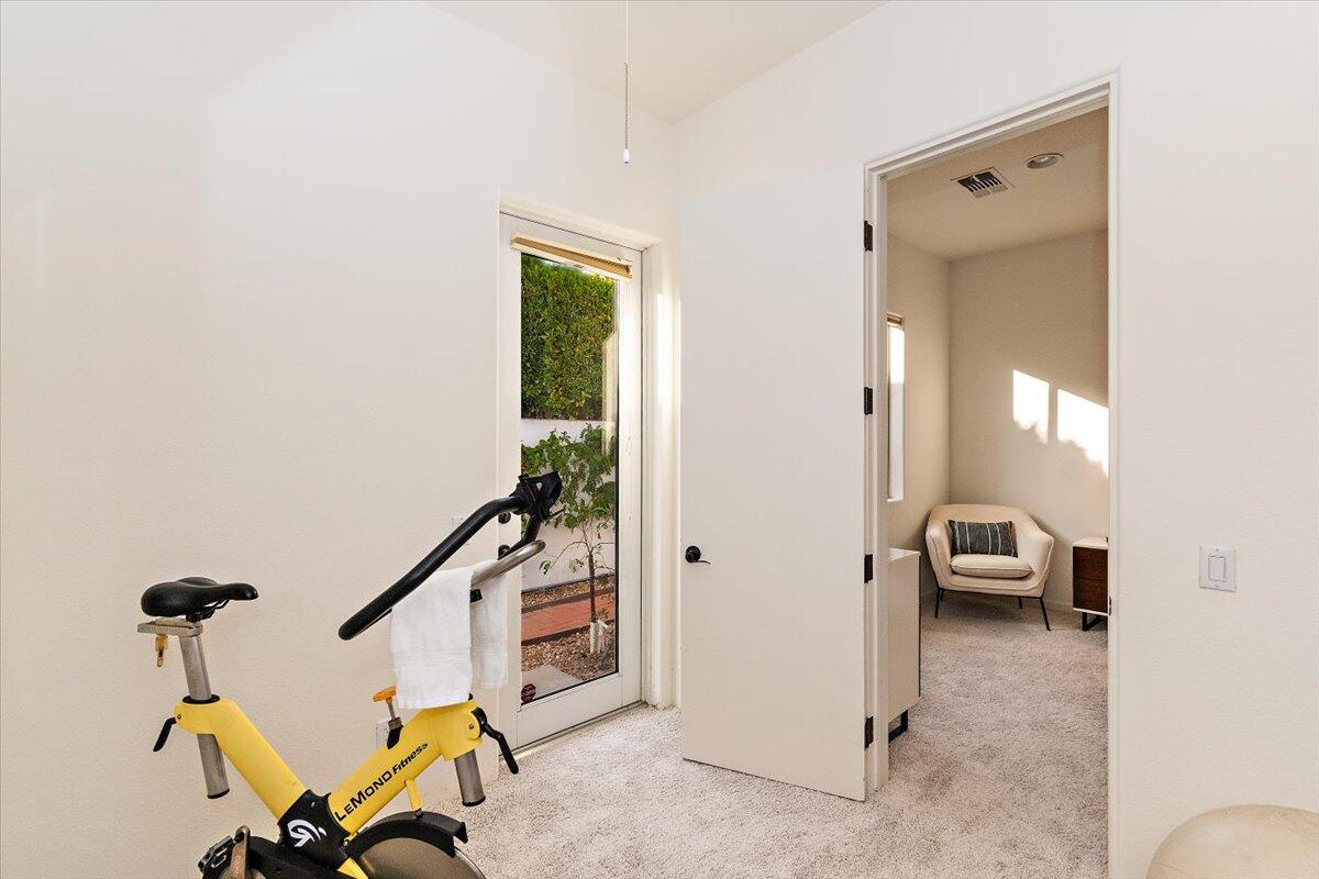 215 Loch Lomond Road Rancho Mirage, CA 92270 - Photo 32 of 57 a view of a hallway with furniture and a window