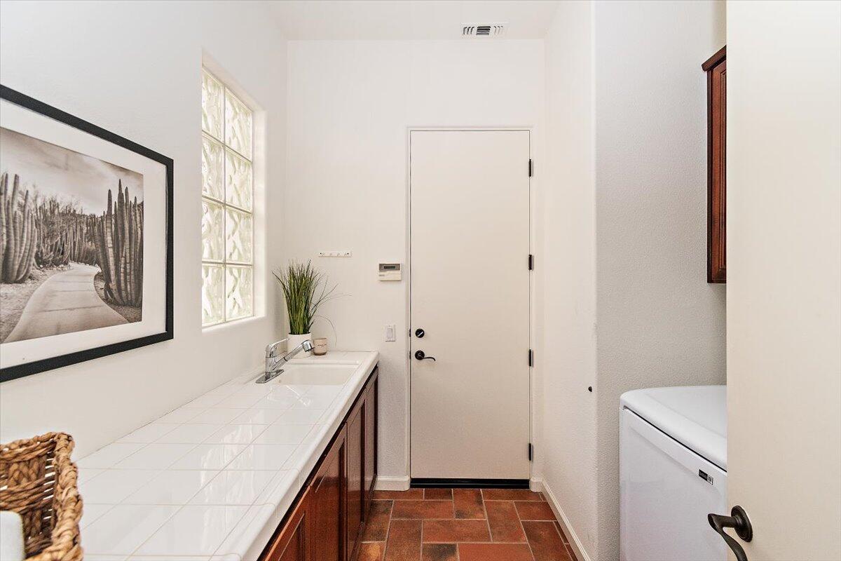 215 Loch Lomond Road Rancho Mirage, CA 92270 - Photo 33 of 57 a bathroom with a sink and a mirror