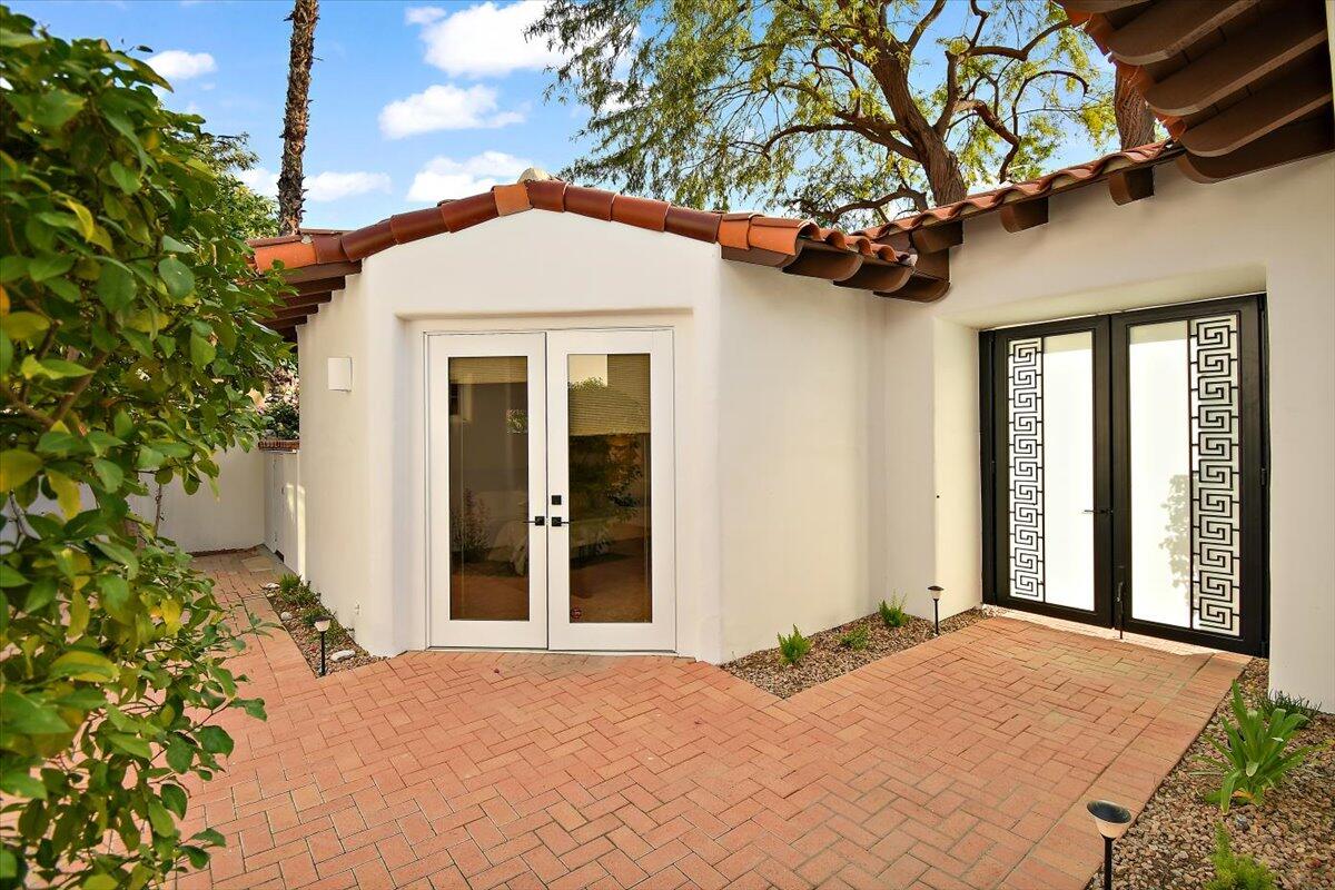 215 Loch Lomond Road Rancho Mirage, CA 92270 - Photo 34 of 57 a front view of a house with a yard