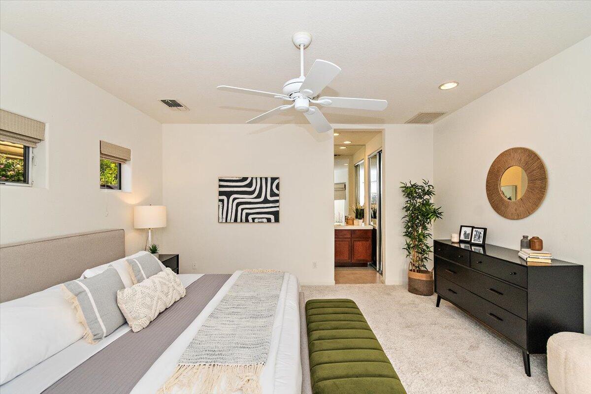 215 Loch Lomond Road Rancho Mirage, CA 92270 - Photo 36 of 57 a bedroom with a bed and a chandelier