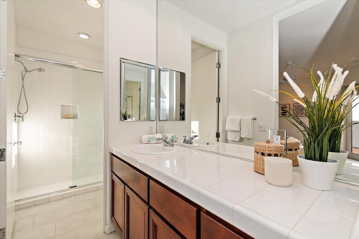215 Loch Lomond Road Rancho Mirage, CA 92270 - Photo 37 of 57 a bathroom with a double vanity sink a mirror and a shower