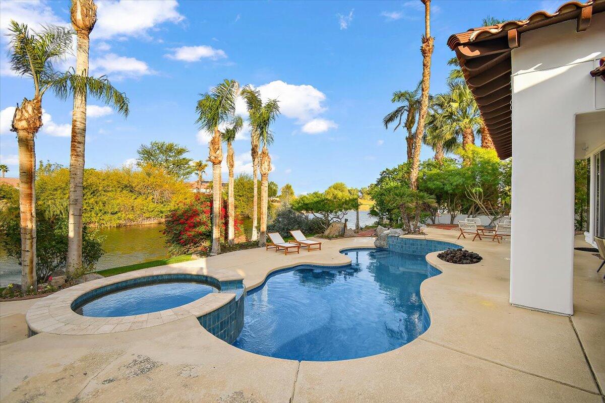 215 Loch Lomond Road Rancho Mirage, CA 92270 - Photo 44 of 57 a view of a swimming pool with a lounge chairs