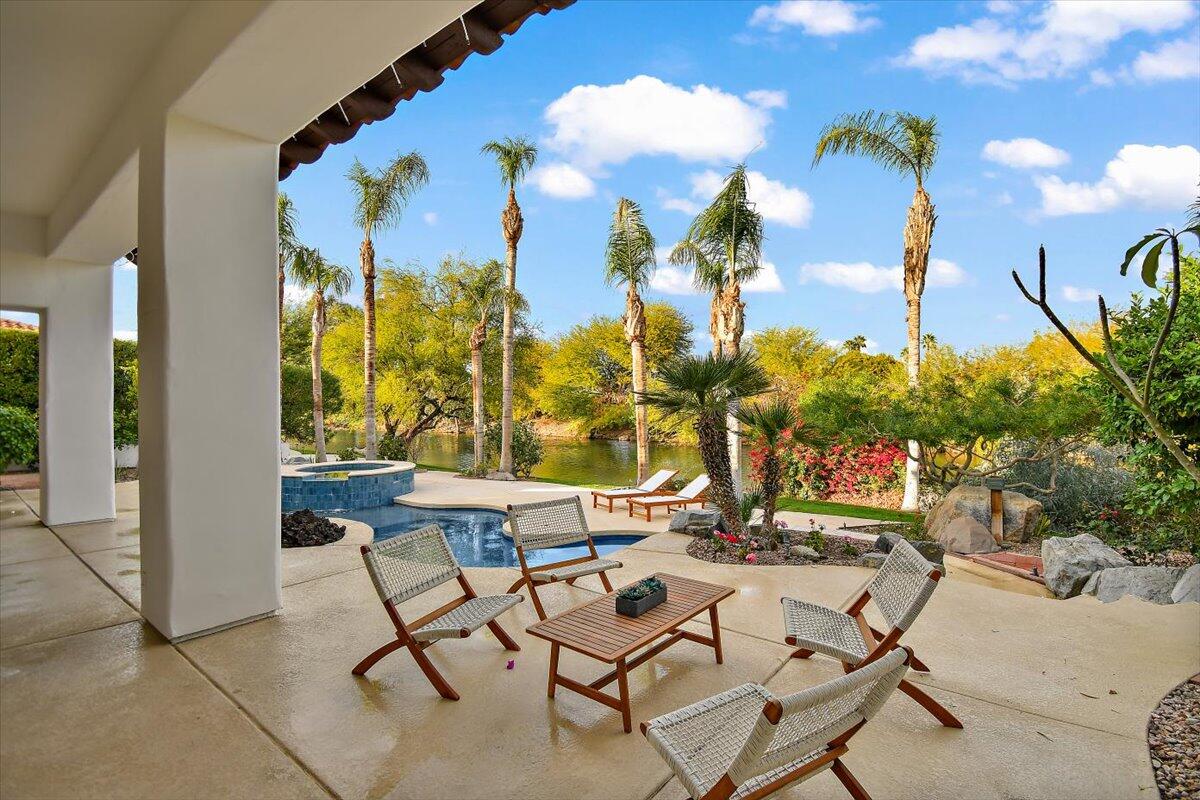 215 Loch Lomond Road Rancho Mirage, CA 92270 - Photo 49 of 57 a view of a patio with dining table and chairs