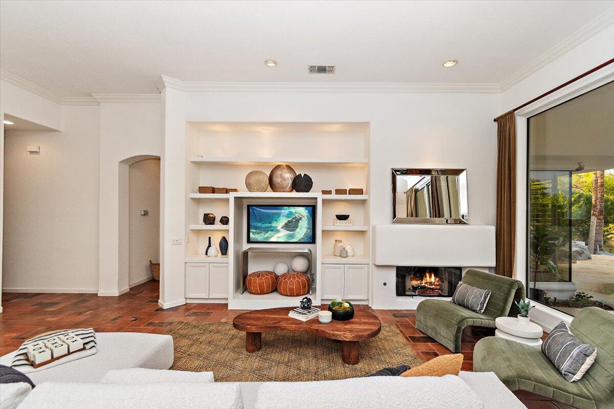 215 Loch Lomond Road Rancho Mirage, CA 92270 - Photo 9 of 57 a living room with furniture fireplace and a window