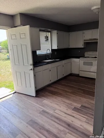 a kitchen with stainless steel appliances a refrigerator sink and cabinets