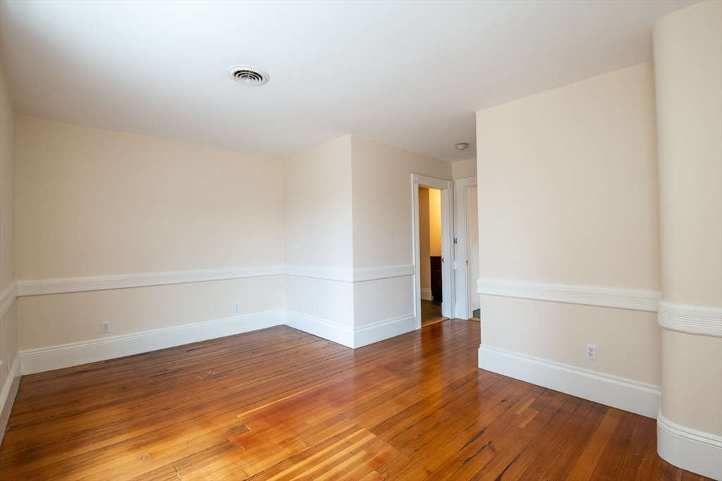 99 Washington Street, Unit 33 Salem, MA 01970 - Photo 12 of 36 a view of an empty room with wooden floor