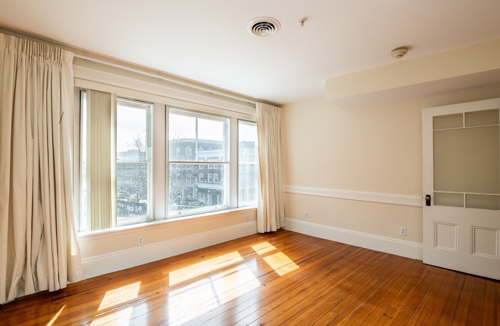 99 Washington Street, Unit 33 Salem, MA 01970 - Photo 18 of 36 a view of an empty room with wooden floor and a window