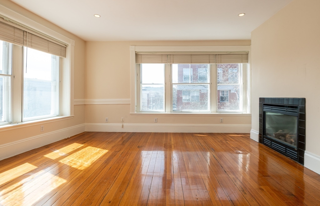 99 Washington Street, Unit 33 Salem, MA 01970 - Photo 26 of 36 a view of an empty room with wooden floor and a window
