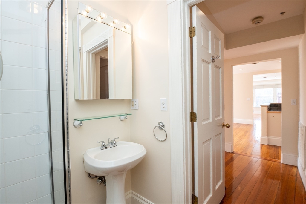 99 Washington Street, Unit 33 Salem, MA 01970 - Photo 29 of 36 a bathroom with a sink a mirror and shower