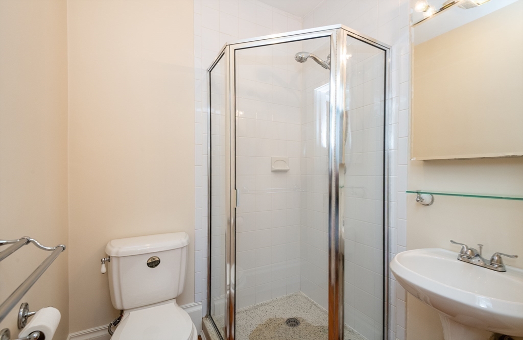 99 Washington Street, Unit 33 Salem, MA 01970 - Photo 30 of 36 a bathroom with a shower a toilet and sink