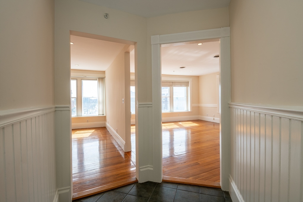 99 Washington Street, Unit 33 Salem, MA 01970 - Photo 8 of 36 a view of empty room with wooden floor and fan