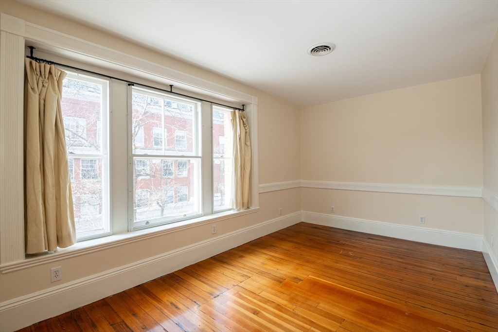 99 Washington Street, Unit 33 Salem, MA 01970 - Photo 10 of 36 a view of an empty room with wooden floor and a window