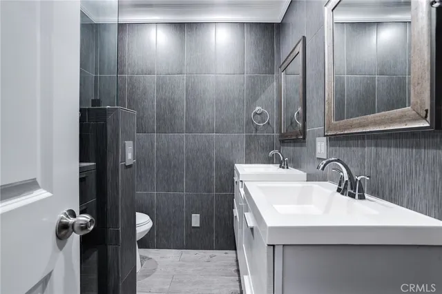 a bathroom with a sink a mirror and shower