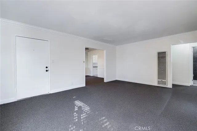 a view of an empty room with closet area