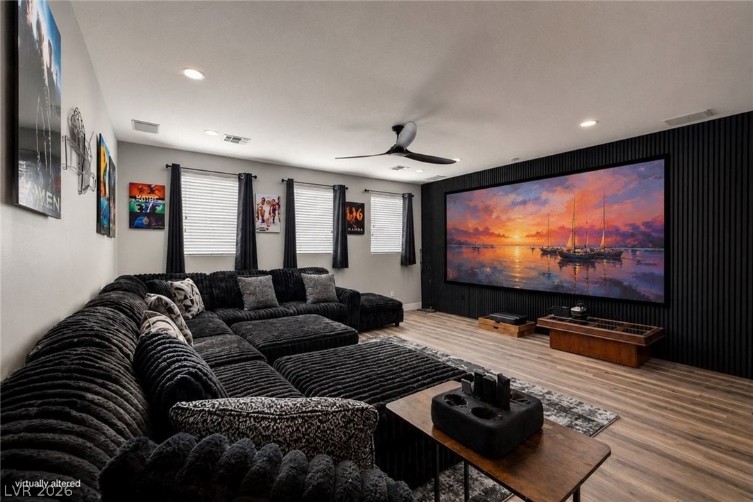 11009 Prairie Grove Road Las Vegas, NV 89179 - Photo 3 of 49 Indulge in cinematic experiences with this spacious media room, offering ample seating and a large projection screen.