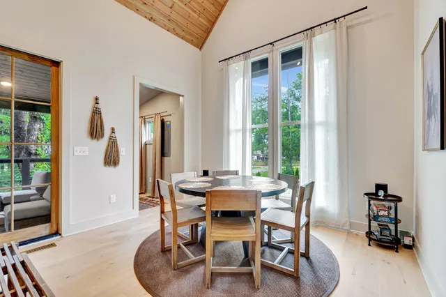a dining room with furniture and a window