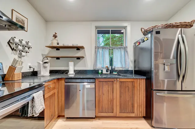 a kitchen with stainless steel appliances a refrigerator and a sink
