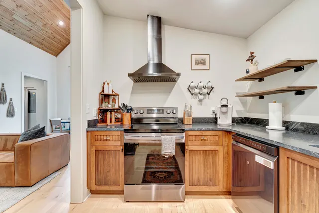 a kitchen with stainless steel appliances granite countertop a stove and a sink