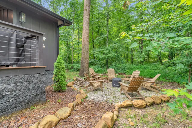 a view of backyard of house with seating space