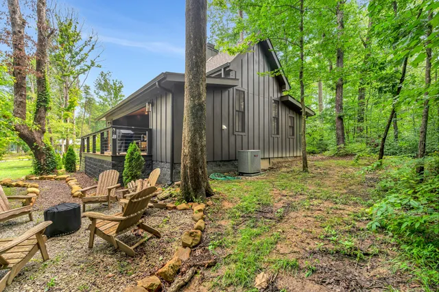 a backyard of a house with table and chairs