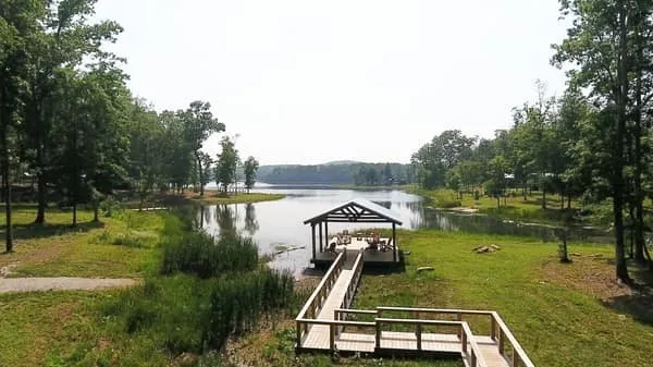 a view of a lake with a yard and trees