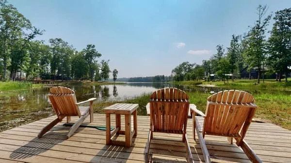 a view of a lake with table and chairs