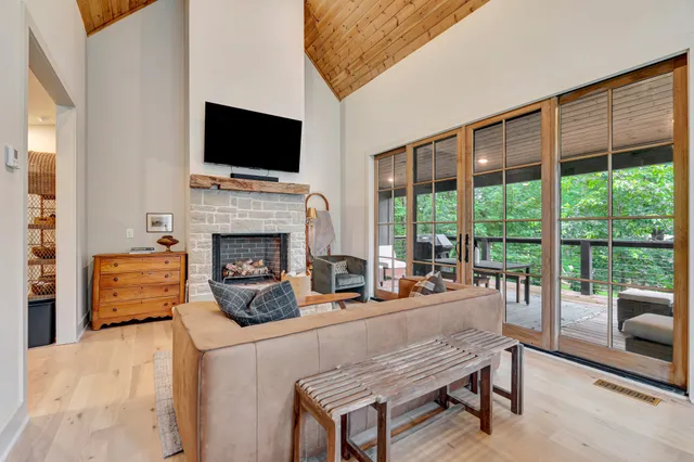 a living room with furniture a fireplace and a flat screen tv