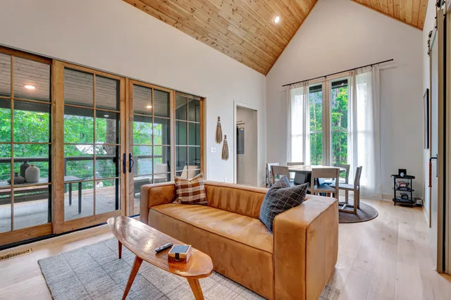 a living room with furniture and large windows
