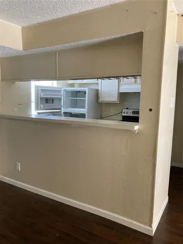 a view of a refrigerator in kitchen and wooden floor