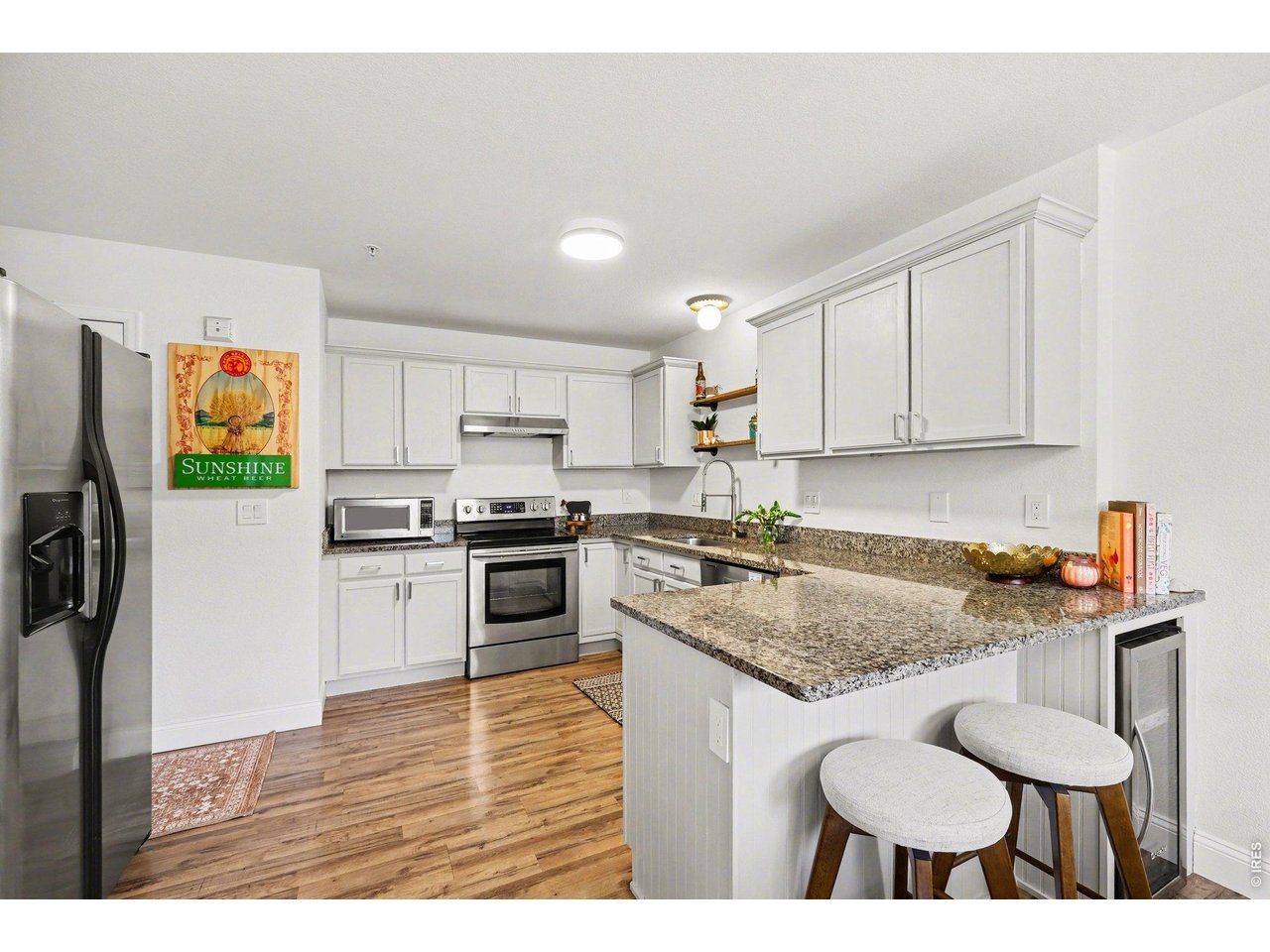 2702 Rigden Parkway, Unit 1 Fort Collins, CO 80525 - Photo 11 of 31 a kitchen with stainless steel appliances granite countertop a sink stove and refrigerator