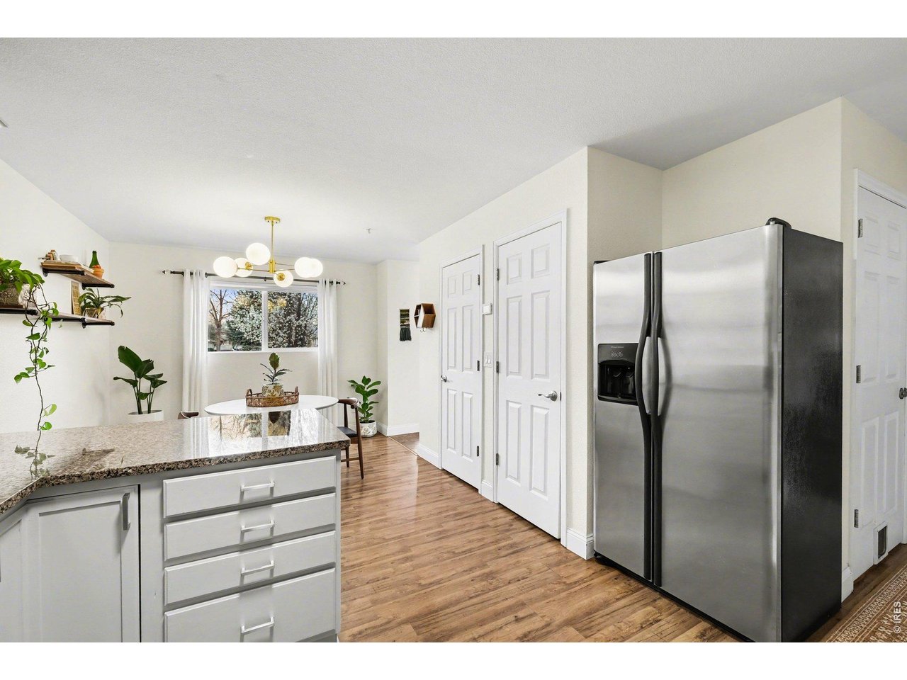 2702 Rigden Parkway, Unit 1 Fort Collins, CO 80525 - Photo 12 of 31 a kitchen with stainless steel appliances a refrigerator and wooden floor
