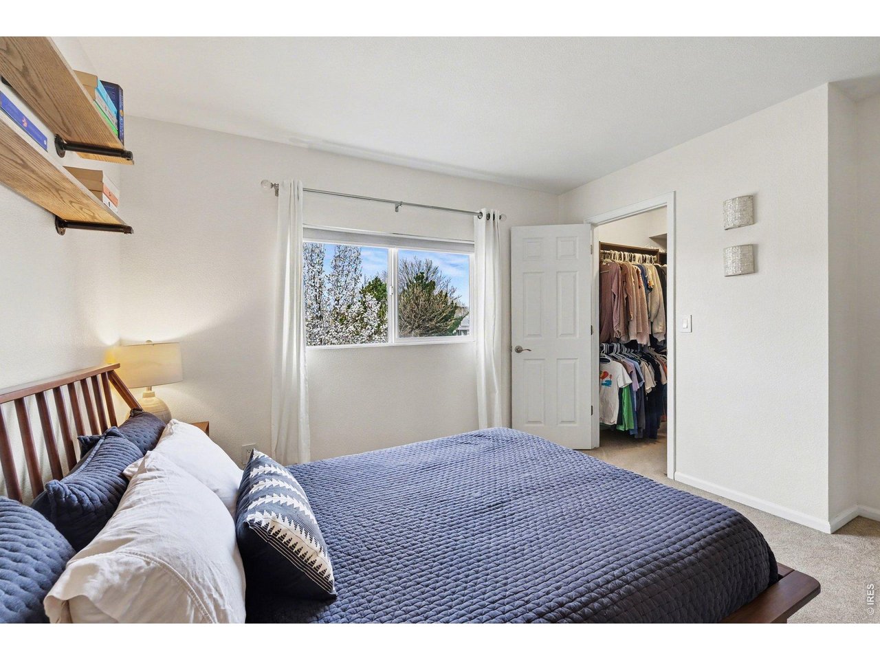 2702 Rigden Parkway, Unit 1 Fort Collins, CO 80525 - Photo 17 of 31 a bedroom with a large bed and a window