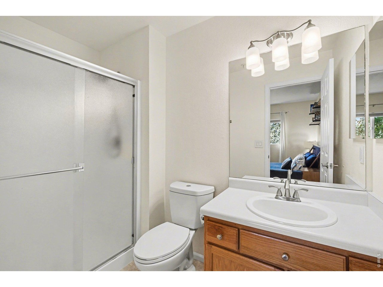 2702 Rigden Parkway, Unit 1 Fort Collins, CO 80525 - Photo 18 of 31 a bathroom with a sink toilet a mirror and shower