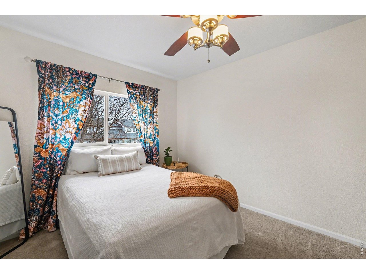 2702 Rigden Parkway, Unit 1 Fort Collins, CO 80525 - Photo 19 of 31 a bedroom with a bed and a chandelier