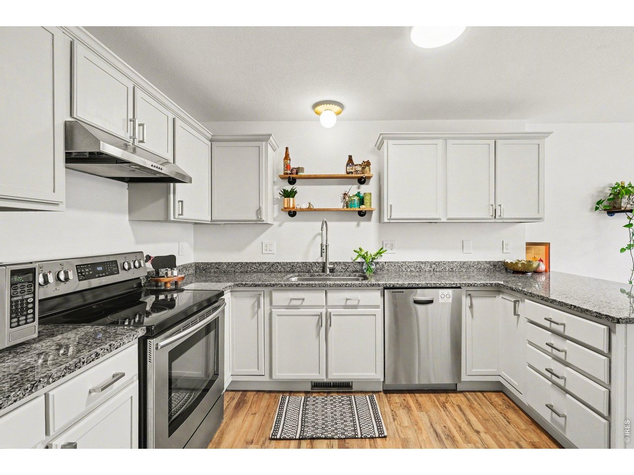 2702 Rigden Parkway, Unit 1 Fort Collins, CO 80525 - Photo 10 of 31 a kitchen with granite countertop a sink stove and cabinets