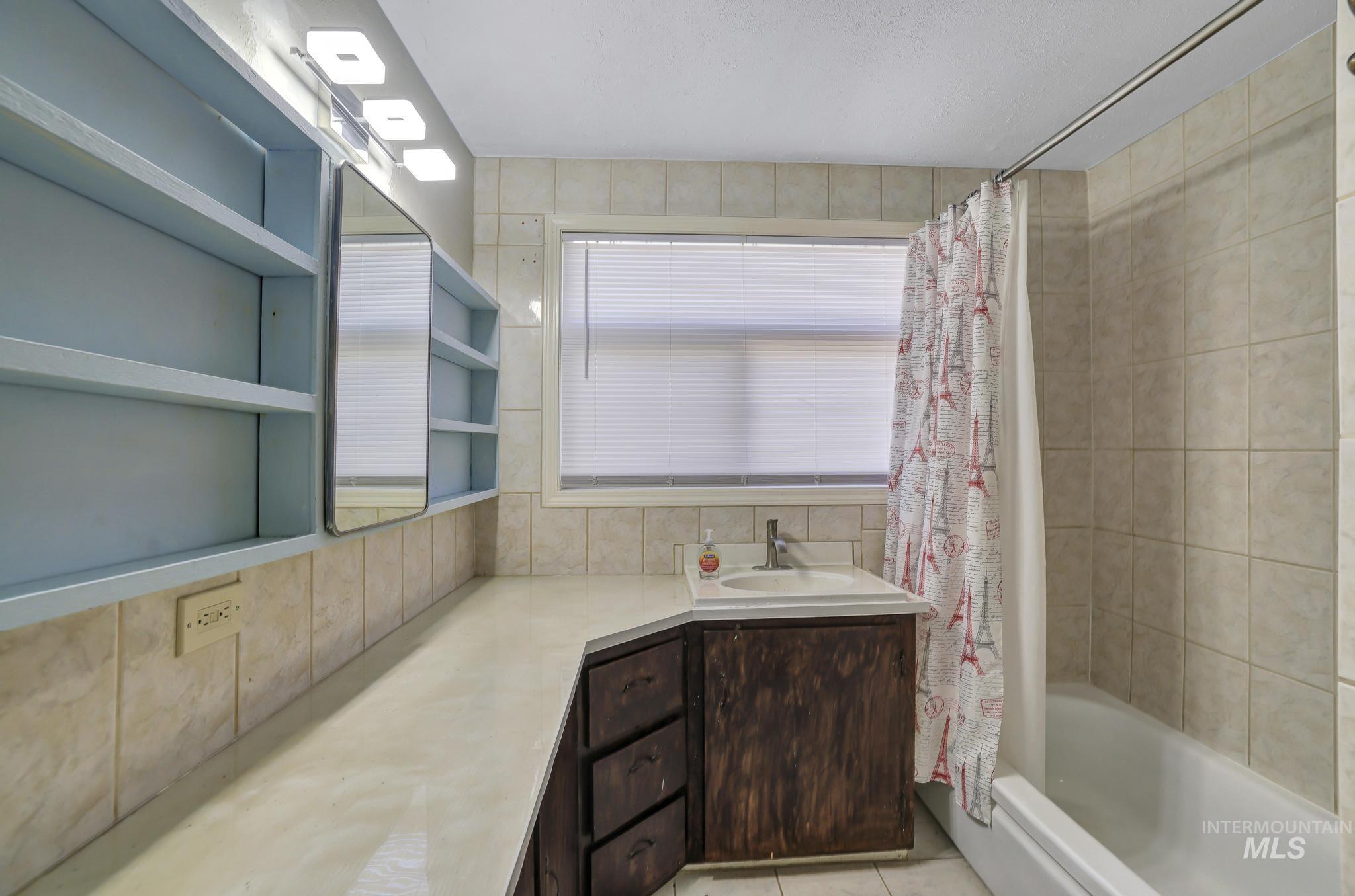 322 Jackson Street Twin Falls, ID 83301 - Photo 22 of 47 Bathroom featuring a built-in vanity with an integrated sink and dark wood-finish cabinetry