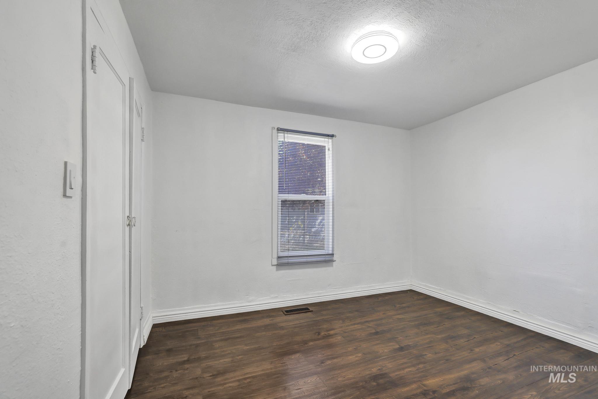 322 Jackson Street Twin Falls, ID 83301 - Photo 23 of 47 Neutral tone interior featuring wood-finish flooring and a single window