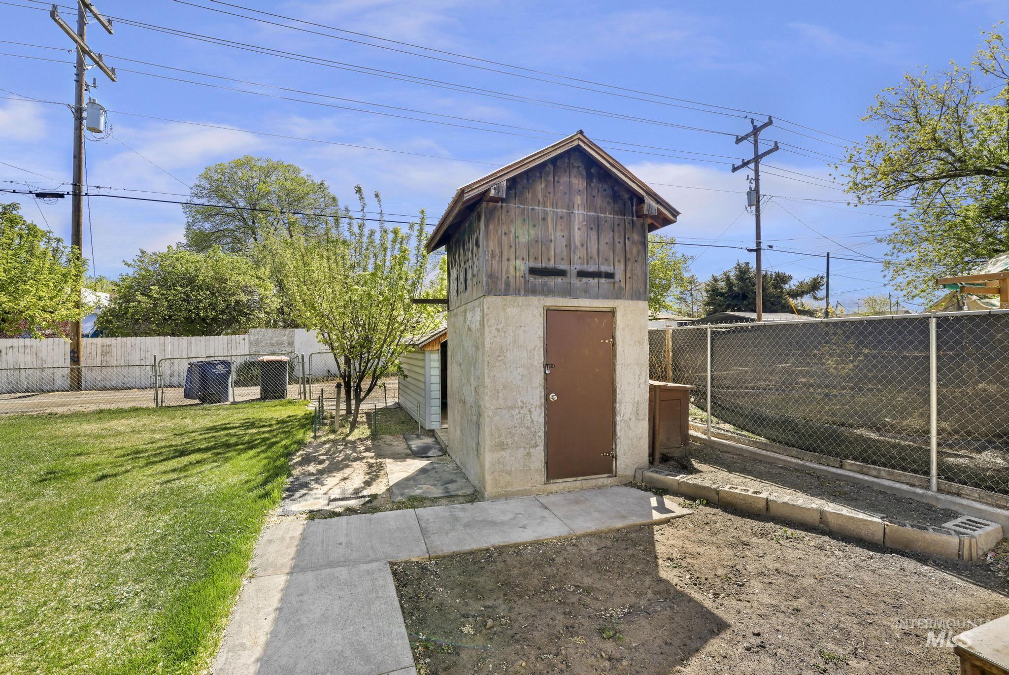 322 Jackson Street Twin Falls, ID 83301 - Photo 29 of 47 Two-story detached outbuilding with a concrete lower level and a wood-sided upper level, featuring a peaked roofline