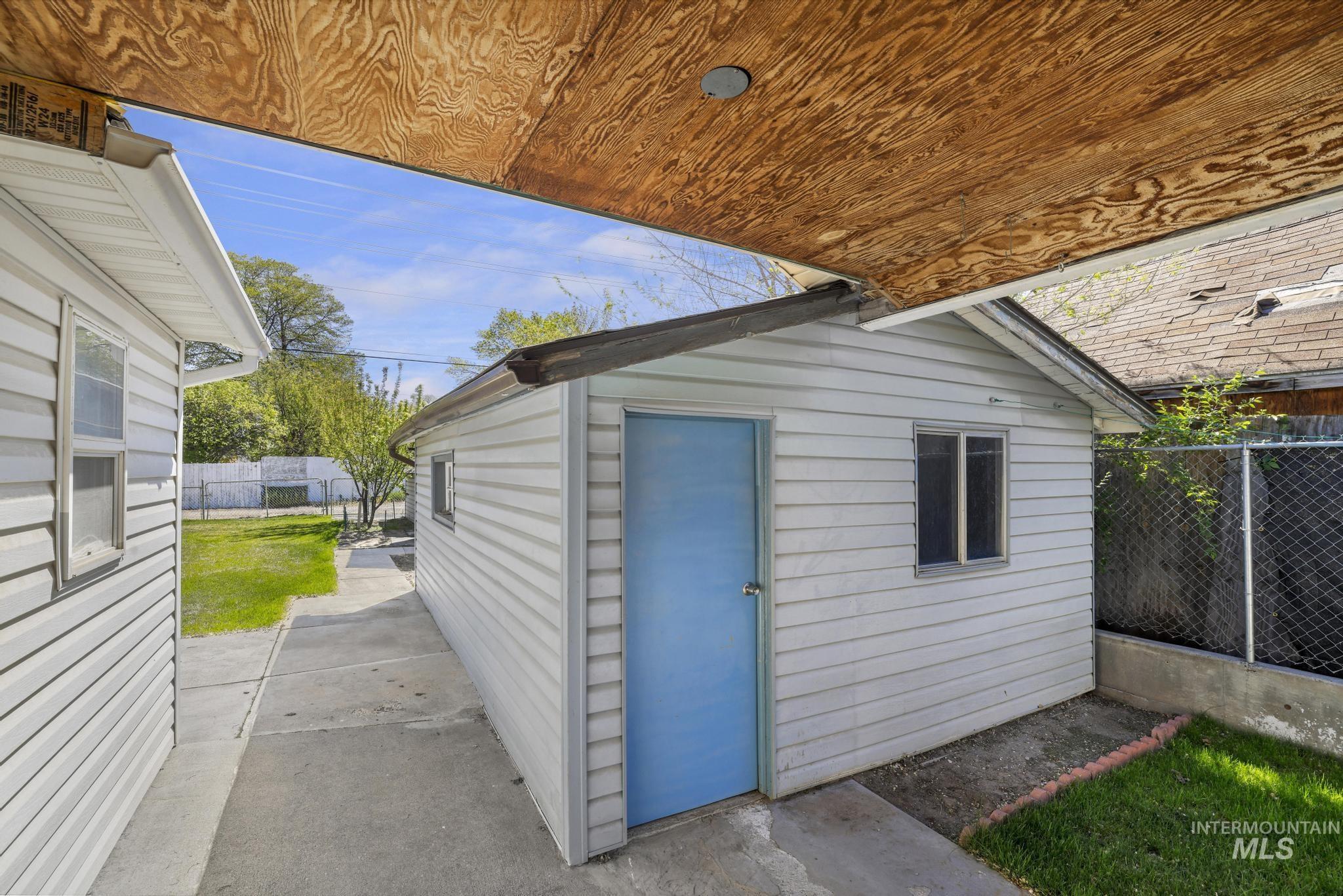 322 Jackson Street Twin Falls, ID 83301 - Photo 32 of 47 Detached outbuilding with light blue door, vinyl siding, and window
