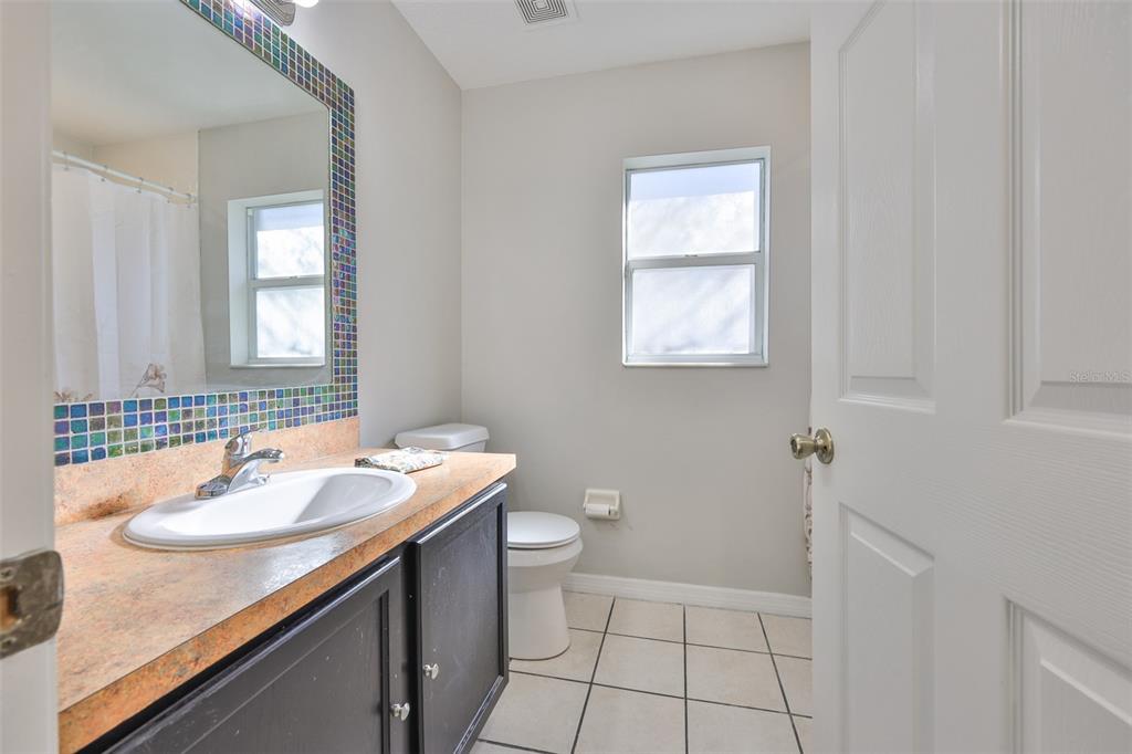 2331 West Chestnut Street Tampa, FL 33607 - Photo 22 of 33 a bathroom with a sink a toilet and mirror