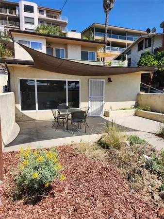 a building outdoor space with patio furniture and potted plants