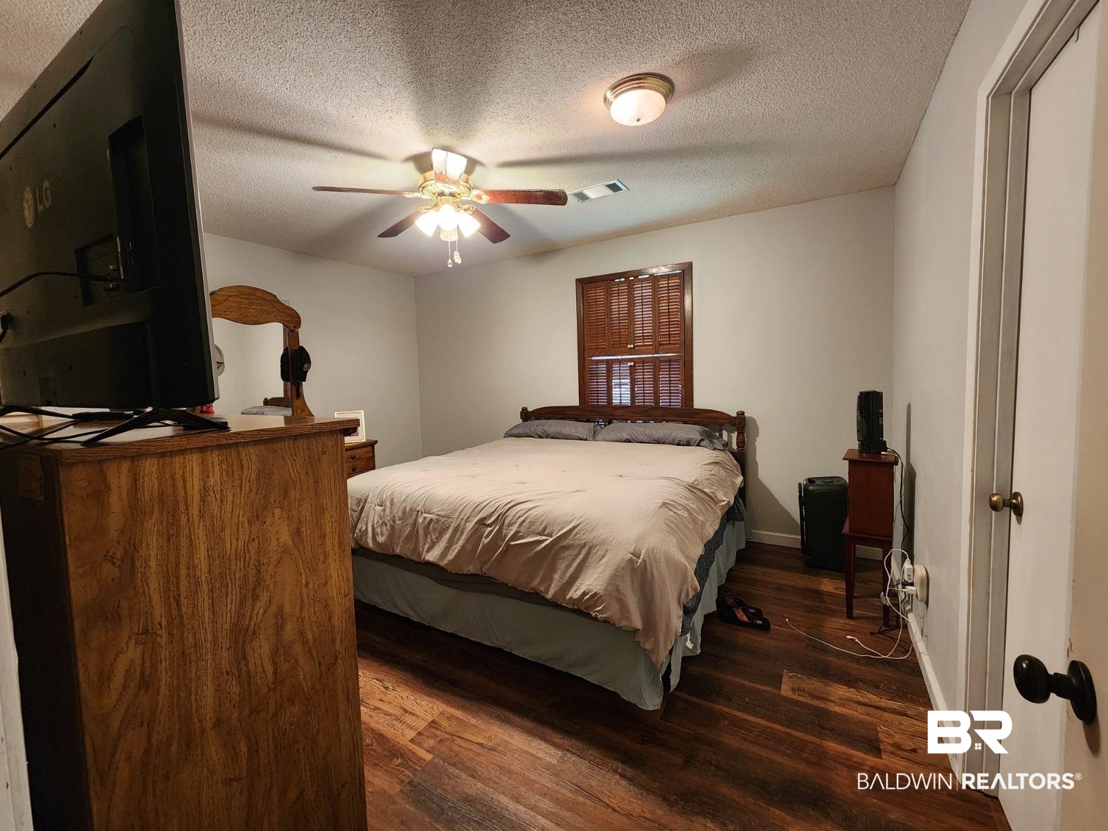 640 Horseshoe Road Brewton, AL 36426 - Photo 18 of 22 Bedroom featuring wood-type flooring, a textured ceiling, and ceiling fan